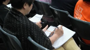 Attendee Taking Notes at Being a Neighbour Workshop by Ian Yap